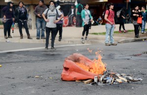 A fire burns in the street after a march. At the end of some protests, students have lit fires, thrown rocks and taunted police officers.