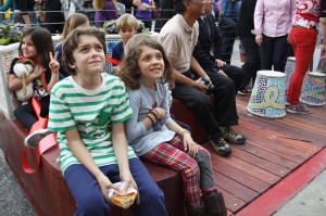 Members of the Highland Park community sit at the newly opened parklet on York Boulevard.