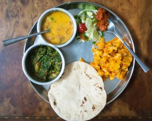 A traditional Gujarati thali (my family is from the western state of Gujarat) with a bowl of dal (lentil soup), a bowl of cooked greens, some mango pickle, salad and bread.  