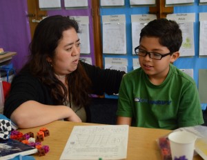 UCLA alumna Sachiko Miyaji helps second-grade student Andres, at Melrose Elementary School. Miyaji recently finished as a runner-up in the Great American Teach-Off competition.  