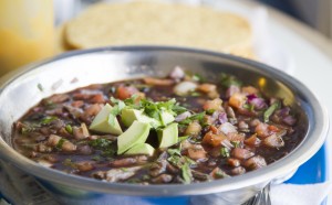 A garnish of avocado provides textural contrast.