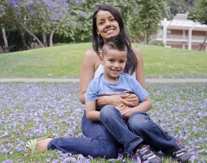 Miriam Torres and her son Louka, 5, sit on the grass together at the Franklin D. Murphy Sculpture Garden.