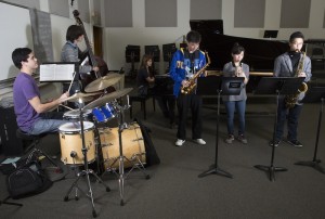 The members of the jazz piano trio "Chrio" practice with three horn players in preparation for their performance Thursday in the Fowler Out Loud concert series.