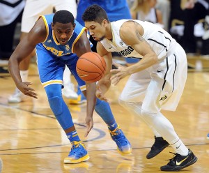 Askia Booker of CU keeps the ball from Jordan Adams of UCLA during the first half of the January 16, 2014 game in Boulder. For more photos of the game, go to www.dailycamera.com.