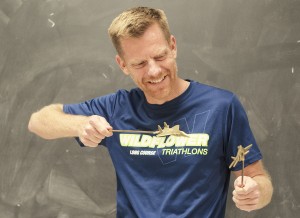 William Peris uses models to show flight patterns he learned in his time with the U.S. Air Force.