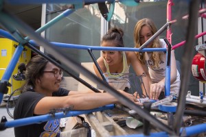 Honesty Kim, a fourth-year bioengineering student, Jessica Leung, a third-year mechanical engineering student, and Christina Daniel, a second-year aerospace engineering student, assemble parts to build a race car. (Austin Yu/Daily Bruin)