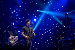 Instrumental trio BADBADNOTGOOD brought twinkling light shows and saxophone melodies to the L.A. Memorial Sports Arena stage Saturday. (Courtesy of Jose Negrete)