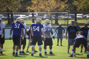 Junior nose tackle Kenny lark (97) and redshirt senior center Jake Brendel (54) are paired up as partners during lineman drills.  (Owen Emerson/Daily Bruin senior staff)